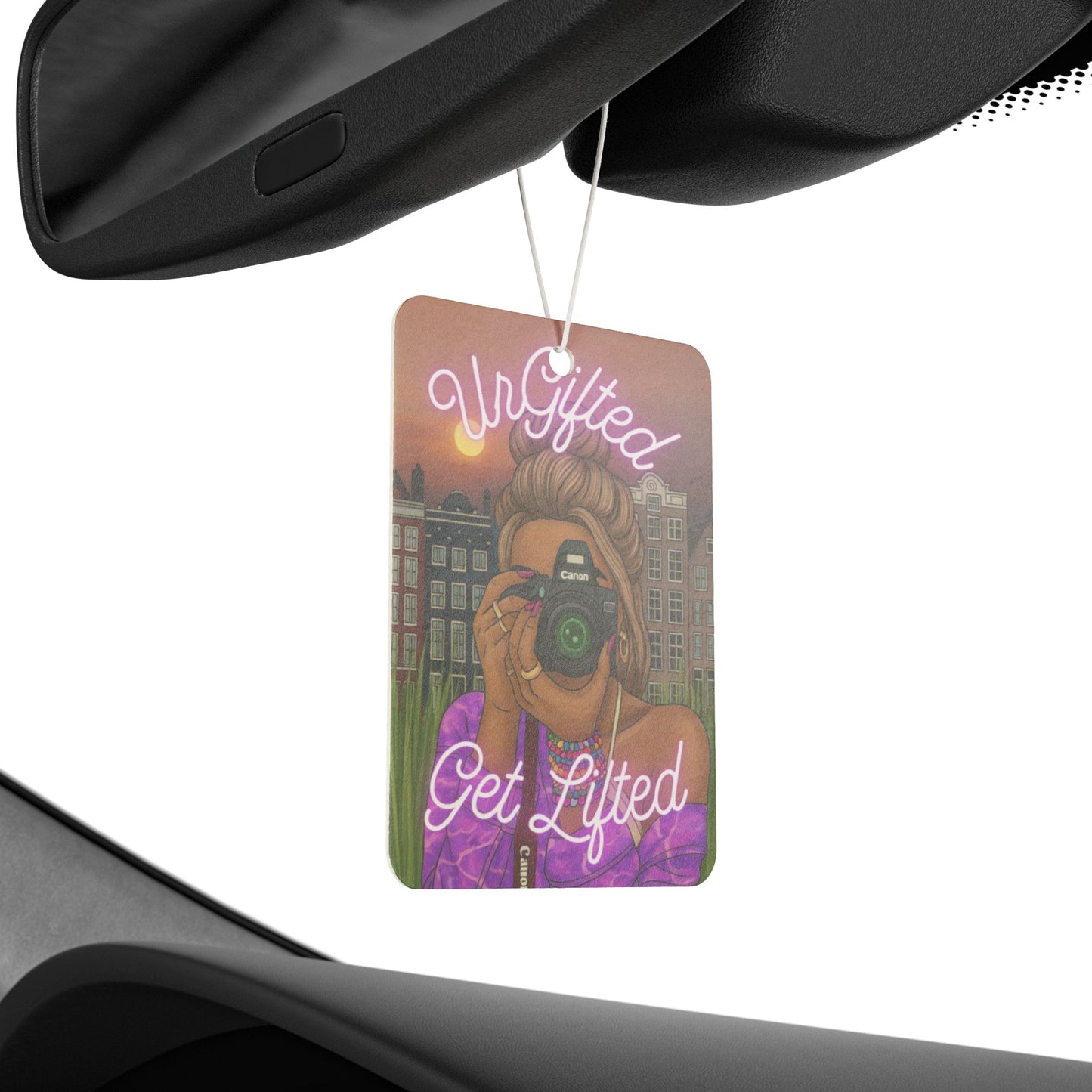 Car air freshener with a design of a woman taking a photo, text 'Ur Gifted' and 'Get Lifted', hanging from a car's rearview mirror.